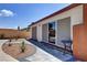 Backyard patio area featuring brick accents, mature landscaping, and a small table at 3920 Autumn St, Las Vegas, NV 89120