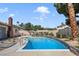 In-ground pool with mature landscaping and desert plants in a private backyard oasis at 3920 Autumn St, Las Vegas, NV 89120