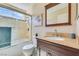 Bright bathroom features a shower-over-tub and dark wood vanity with granite countertop at 3920 Autumn St, Las Vegas, NV 89120
