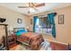 Cozy bedroom features a ceiling fan, wood floors, and a large window with curtains at 3920 Autumn St, Las Vegas, NV 89120