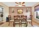 Cozy dining area with a glass-top table, six chairs, and bright natural light streaming through the window at 3920 Autumn St, Las Vegas, NV 89120