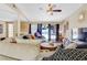 Spacious living room with a large sectional sofa, wood floors, and sliding doors leading to the pool at 3920 Autumn St, Las Vegas, NV 89120