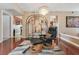 Open-plan living room with hardwood floors, a chandelier, and dining area at 3920 Autumn St, Las Vegas, NV 89120