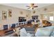 Bright living room featuring hardwood floors, a large sectional sofa, and a ceiling fan at 3920 Autumn St, Las Vegas, NV 89120