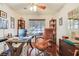 Well-lit home office with wood floors, ceiling fan, shelving and large window at 3920 Autumn St, Las Vegas, NV 89120
