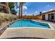Backyard pool with desert landscaping and a perimeter wall for privacy at 3920 Autumn St, Las Vegas, NV 89120