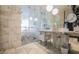 Luxurious bathroom with marble tiling, modern fixtures, and a glass-enclosed shower at 4381 W Flamingo Rd # 1212, Las Vegas, NV 89103