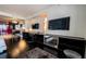 Spacious bedroom with dark wood floors, mounted TVs, and modern shelving at 4381 W Flamingo Rd # 1212, Las Vegas, NV 89103