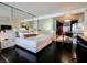 Sleek main bedroom featuring modern decor, dark wood floors, and an adjoining kitchen at 4381 W Flamingo Rd # 1212, Las Vegas, NV 89103