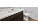 Close-up of a modern bathroom vanity with a white countertop, dark wood cabinet, and sleek fixtures at 4510 E Brusca Way, Pahrump, NV 89061