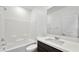 Bright bathroom featuring a shower-tub combo, white subway tile, and a vanity with a dark wood cabinet at 4510 E Brusca Way, Pahrump, NV 89061
