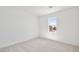 Cozy bedroom with neutral carpet, bright walls, and a window that lets in natural light, creating a serene space at 4510 E Brusca Way, Pahrump, NV 89061