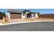 Charming single-story home with a brick driveway and a two-car garage, set against a clear blue sky at 4510 E Brusca Way, Pahrump, NV 89061