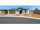 Charming single-story home with a brick driveway and a two-car garage, set against a clear blue sky at 4510 E Brusca Way, Pahrump, NV 89061