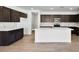 Stylish kitchen featuring dark wood cabinetry, white counters and a center island at 4510 E Brusca Way, Pahrump, NV 89061