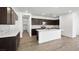 Modern kitchen featuring dark wood cabinets, white counters, and stainless steel appliances at 4510 E Brusca Way, Pahrump, NV 89061