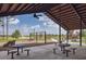 Community pavilion with picnic tables and swings overlooking a green lawn at 4510 E Brusca Way, Pahrump, NV 89061