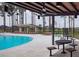 Resort-style pool area with lounge chairs, picnic tables, and shaded seating for relaxation at 4510 E Brusca Way, Pahrump, NV 89061