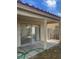 Covered back patio with sliding glass doors leading to a living area with views to the backyard at 4931 Crystal Breeze Ln, North Las Vegas, NV 89031