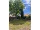 Backyard featuring mature shade tree, block wall, and desert landscaping in a well maintained yard at 4931 Crystal Breeze Ln, North Las Vegas, NV 89031