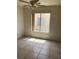 This neutral toned bedroom features tile flooring and natural light from a large window at 4931 Crystal Breeze Ln, North Las Vegas, NV 89031