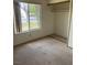 Neutral bedroom features carpet, window overlooking front yard and closet at 4931 Crystal Breeze Ln, North Las Vegas, NV 89031