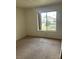 Neutral bedroom featuring a window overlooking the front yard, carpet and closet at 4931 Crystal Breeze Ln, North Las Vegas, NV 89031