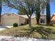 Charming single-story home with a well-maintained front yard, mature trees, and attached two car garage at 4931 Crystal Breeze Ln, North Las Vegas, NV 89031