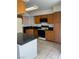 Traditional kitchen featuring wood cabinetry, black granite countertops and stainless steel gas range at 4931 Crystal Breeze Ln, North Las Vegas, NV 89031