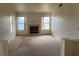 Carpeted living room showcases a fireplace as a focal point and offers ample natural light at 4931 Crystal Breeze Ln, North Las Vegas, NV 89031