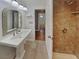 Bathroom featuring a stand alone sink, decorative mirror, and tiled walk-in shower at 5043 Spencer St # A, Las Vegas, NV 89119
