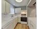 Well-lit kitchen boasting white cabinets, countertops, and appliances at 5043 Spencer St # A, Las Vegas, NV 89119