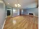 Open-concept living room with hardwood floors, a fireplace, and seamless connection to the kitchen at 5043 Spencer St # A, Las Vegas, NV 89119
