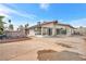 Expansive backyard offers ample space, and covered patio with mature trees and a stone feature at 5120 Burnham Ave, Las Vegas, NV 89119