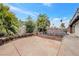 Large backyard featuring desert landscaping, mature trees, and decorative concrete work at 5120 Burnham Ave, Las Vegas, NV 89119
