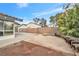 Spacious backyard featuring a brick wall, desert landscaping, and an open patio area at 5120 Burnham Ave, Las Vegas, NV 89119