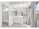 Bright bathroom featuring a modern vanity, a tub, and sliding glass door at 5120 Burnham Ave, Las Vegas, NV 89119