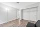 Inviting bedroom features wood-look flooring, closet space, and soft, neutral walls at 5120 Burnham Ave, Las Vegas, NV 89119