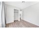 Neutrally decorated bedroom featuring wood-look flooring and a closet with sliding doors at 5120 Burnham Ave, Las Vegas, NV 89119