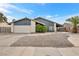 Inviting home exterior featuring desert landscaping, a two-car garage, and a charming facade at 5120 Burnham Ave, Las Vegas, NV 89119