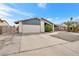 Charming single-story home featuring a two car garage, manicured landscaping, and a long driveway at 5120 Burnham Ave, Las Vegas, NV 89119