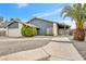 Single-story home featuring a two car garage, manicured landscaping, and a wide driveway at 5120 Burnham Ave, Las Vegas, NV 89119