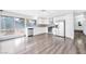 Open kitchen and dining area with stainless steel appliances, grey backsplash, and a view to a landscaped backyard at 5120 Burnham Ave, Las Vegas, NV 89119