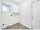 Practical laundry room features overhead storage and a door, perfect for home tasks at 5120 Burnham Ave, Las Vegas, NV 89119