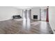 Open living room features wood floors, large windows, and a modern fireplace with stone accents at 5120 Burnham Ave, Las Vegas, NV 89119