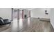 Spacious living room featuring wood floors, large windows, and backyard views at 5120 Burnham Ave, Las Vegas, NV 89119