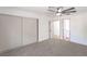 Bedroom featuring modern ceiling fan, closet, access to bathroom and neutral color palette at 5239 Elgin Cir, Las Vegas, NV 89122