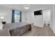 Bedroom featuring an ensuite bathroom, plank flooring, and blue window coverings at 5241 Janfred Ct # 26, Las Vegas, NV 89103