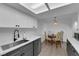 This kitchen showcases gray and white cabinets, stainless sink, and a skylight for natural lighting at 5241 Janfred Ct # 26, Las Vegas, NV 89103