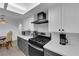 Modern kitchen featuring stainless steel appliances and a stylish vent hood and wood grain flooring at 5241 Janfred Ct # 26, Las Vegas, NV 89103